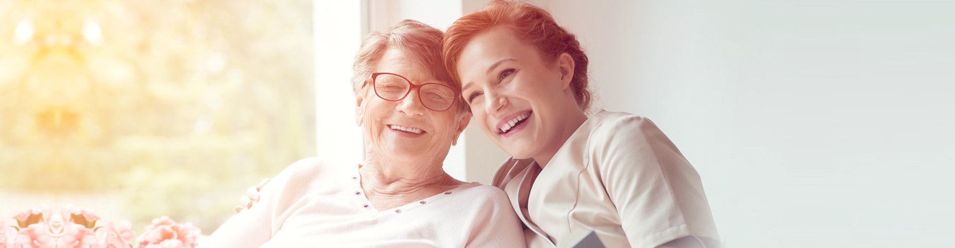 middle aged woman enjoying a bright morning with an elderly woman